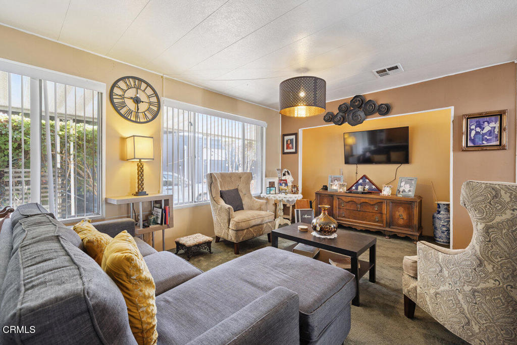 1550 Rory Lane, Unit 82 Simi Valley, CA 93063 - Photo 9 of 27 a living room with furniture and a flat screen tv