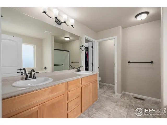 a view of walk in closet with clothes