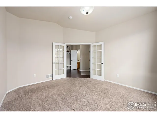 an empty room with windows and closet