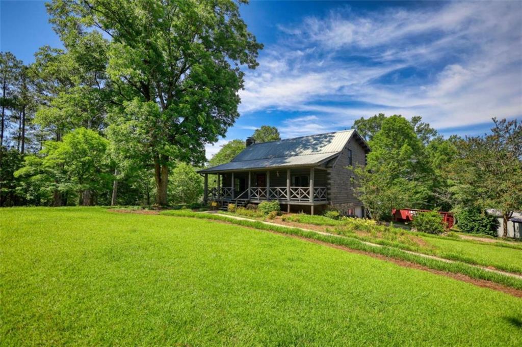 2665 Macedonia Road Franklin, GA 30217 - Photo 3 of 68 a front view of a house with swimming pool having outdoor seating