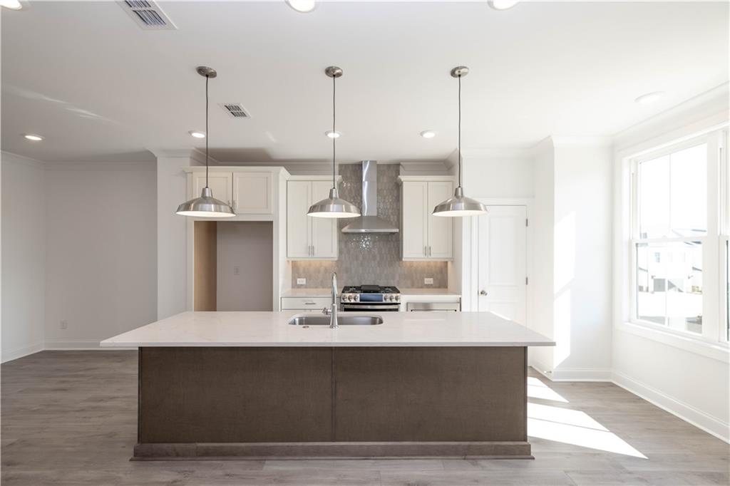 4223 Millcroft Place, Unit 211 Buford, GA 30518 - Photo 13 of 47 a view of kitchen with stainless steel appliances granite countertop cabinets and wooden floor