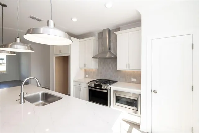a kitchen with granite countertop a stove and a sink