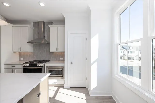a stove top oven sitting inside of a kitchen