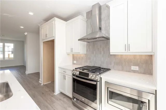 a kitchen with stove a sink and refrigerator