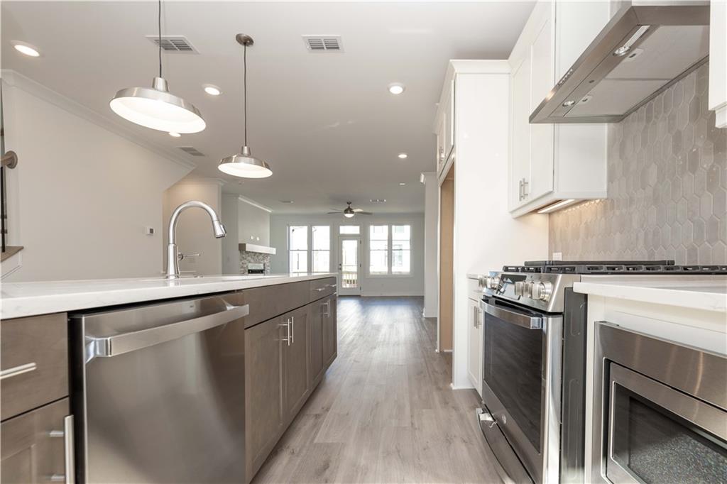4223 Millcroft Place, Unit 211 Buford, GA 30518 - Photo 20 of 47 a kitchen with stove a sink and refrigerator
