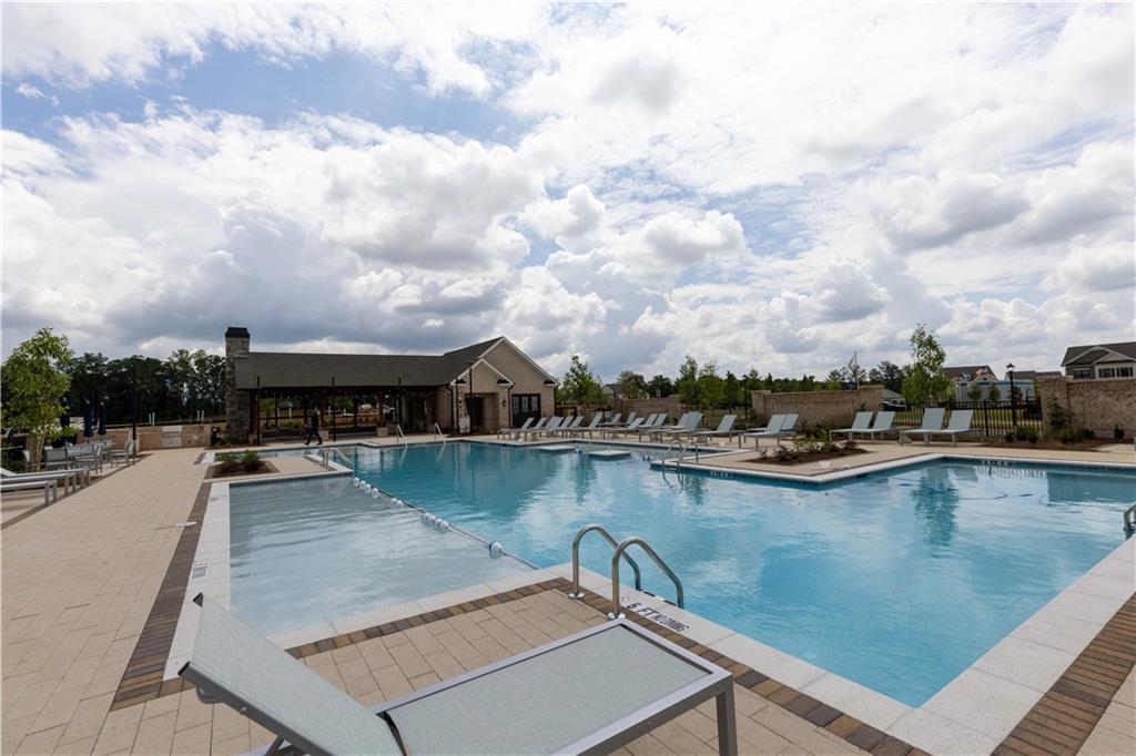 4223 Millcroft Place, Unit 211 Buford, GA 30518 - Photo 39 of 47 a view of a swimming pool with outdoor seating