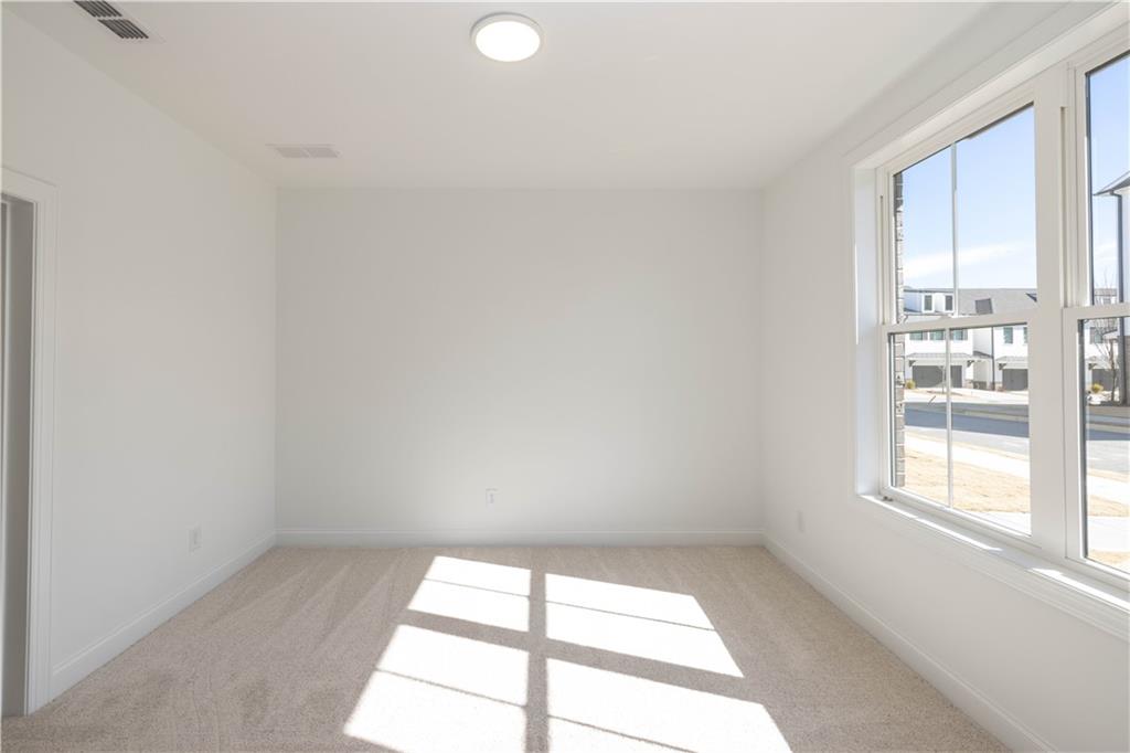 4223 Millcroft Place, Unit 211 Buford, GA 30518 - Photo 6 of 47 an empty room with a window
