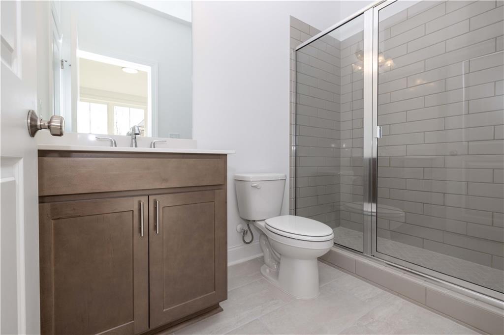4223 Millcroft Place, Unit 211 Buford, GA 30518 - Photo 8 of 47 a bathroom with a sink toilet and shower