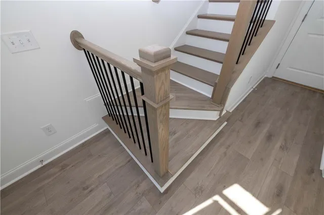 a large kitchen with a wooden floor and stainless steel appliances