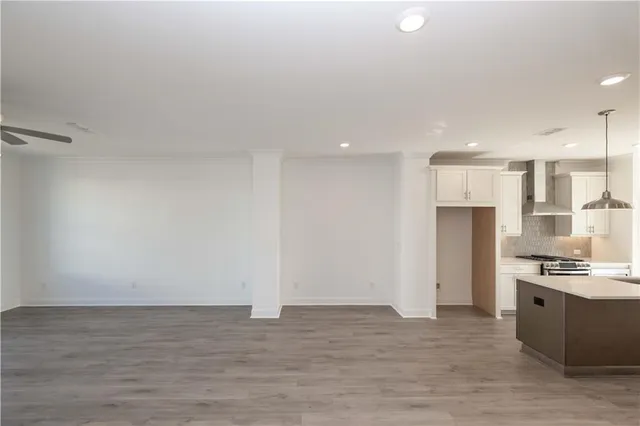a kitchen with stainless steel appliances and wooden floor