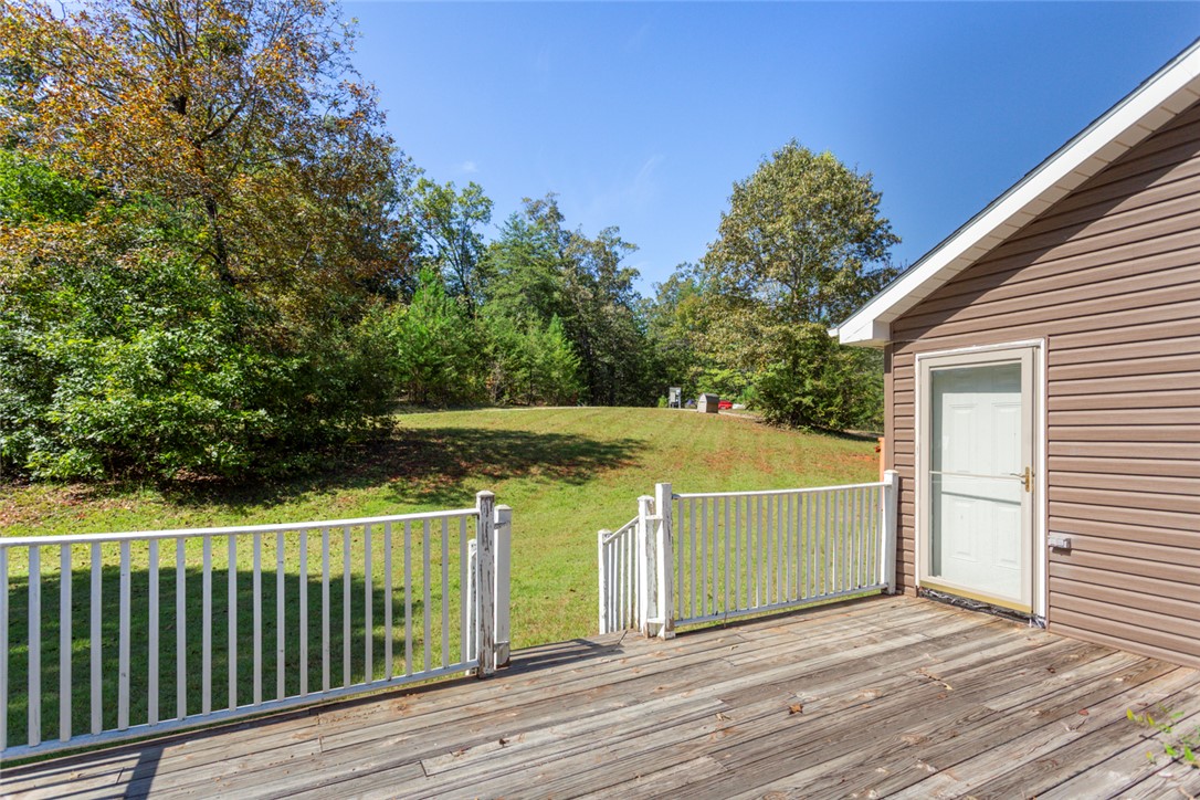 621 Burns Mill Road West Union, SC 29696 - Photo 28 of 45 A spacious wooden deck transitions to a lush, verdant lawn, offering an inviting outdoor retreat.