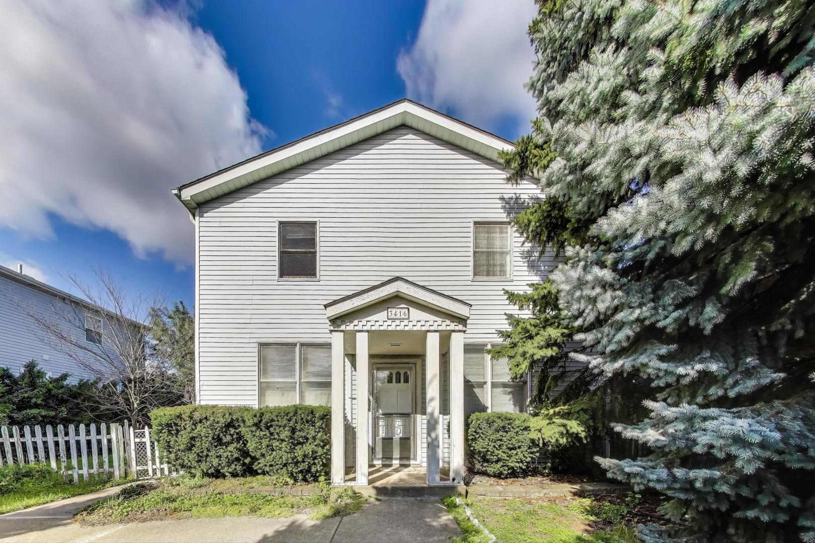 a view of front of house with a yard