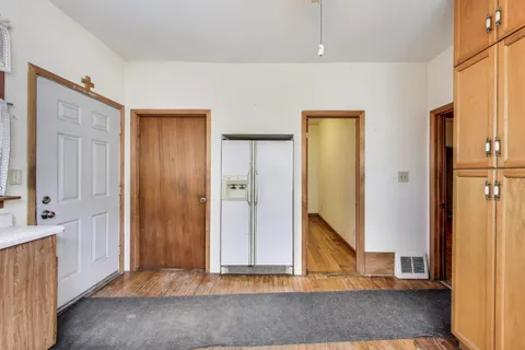 a view of entryway with wooden floor and cabinet