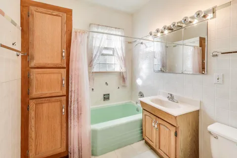 a bathroom with a sink a mirror and a bathtub
