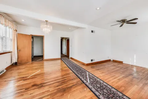 a view of a room with wooden floor