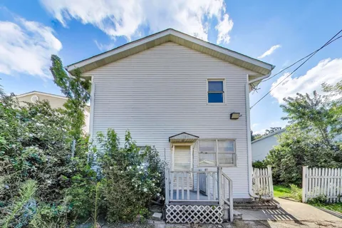 a picture of a painting of a small white building