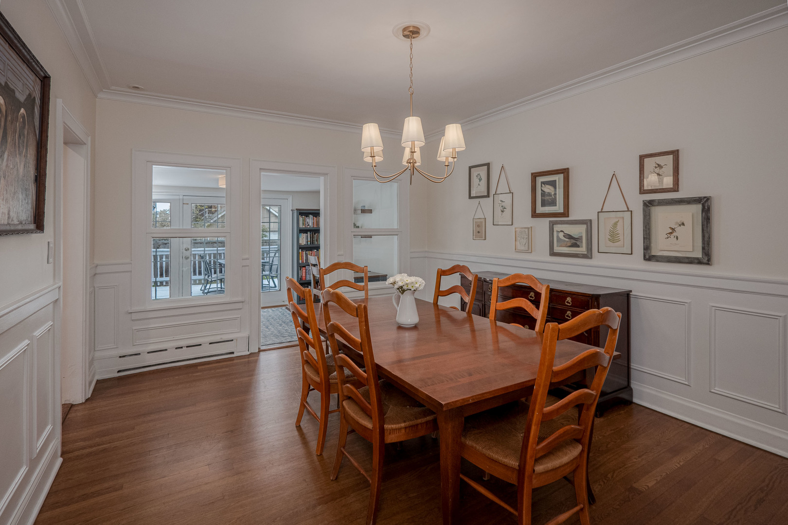 1204 Madison Street Evanston, IL 60202 - Photo 13 of 56 a dining room with wooden floor a chandelier a wooden table and chairs