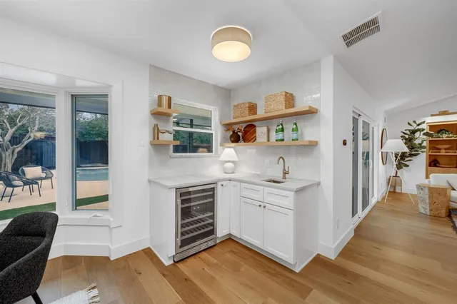 a view of kitchen with stainless steel appliances cabinets and wooden floor
