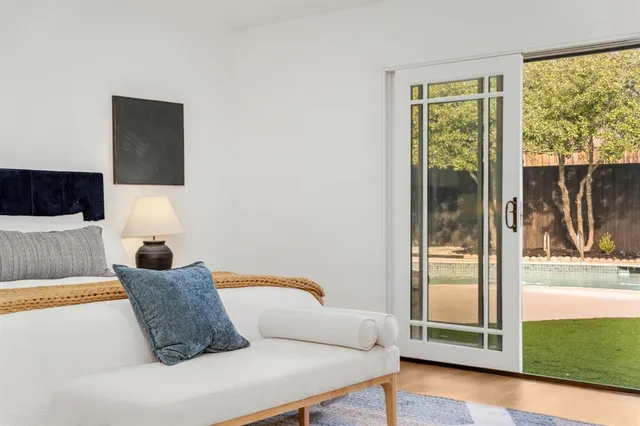 a bedroom with a large bed and a window