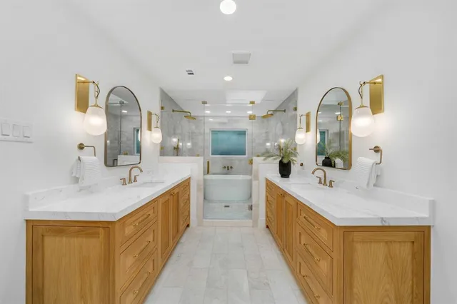 a bathroom with a double vanity sink and a mirror