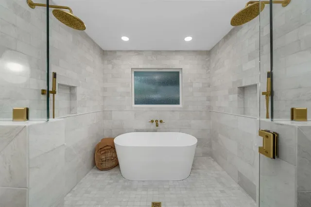 a bathroom with a bathtub and shower