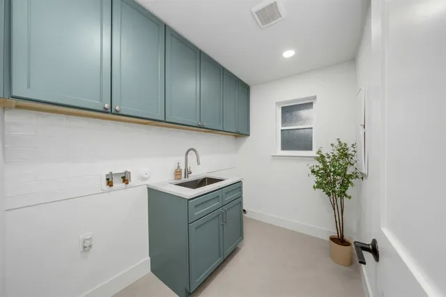 a view of a kitchen with sink and cabinets