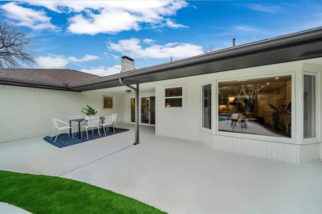 a view of a porch with furniture and a small yard