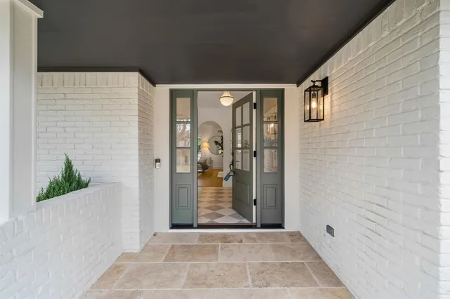 a view of a porch with wooden floor and a potted plant