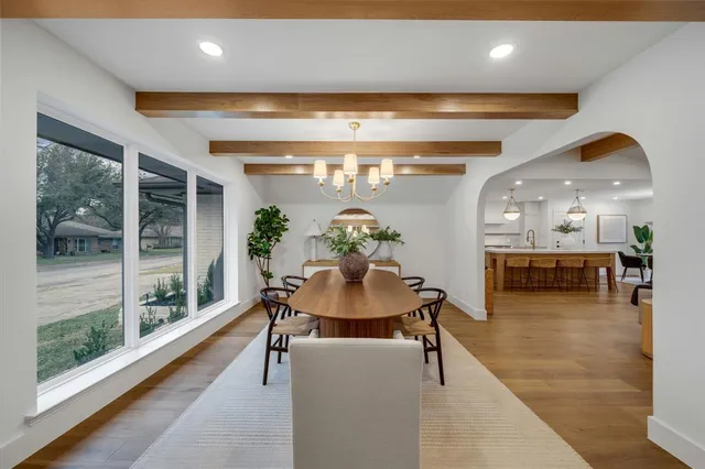 a view of a dining room with furniture and a floor to ceiling window