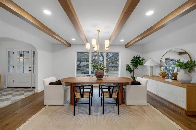 a view of a dining room with furniture and chandelier