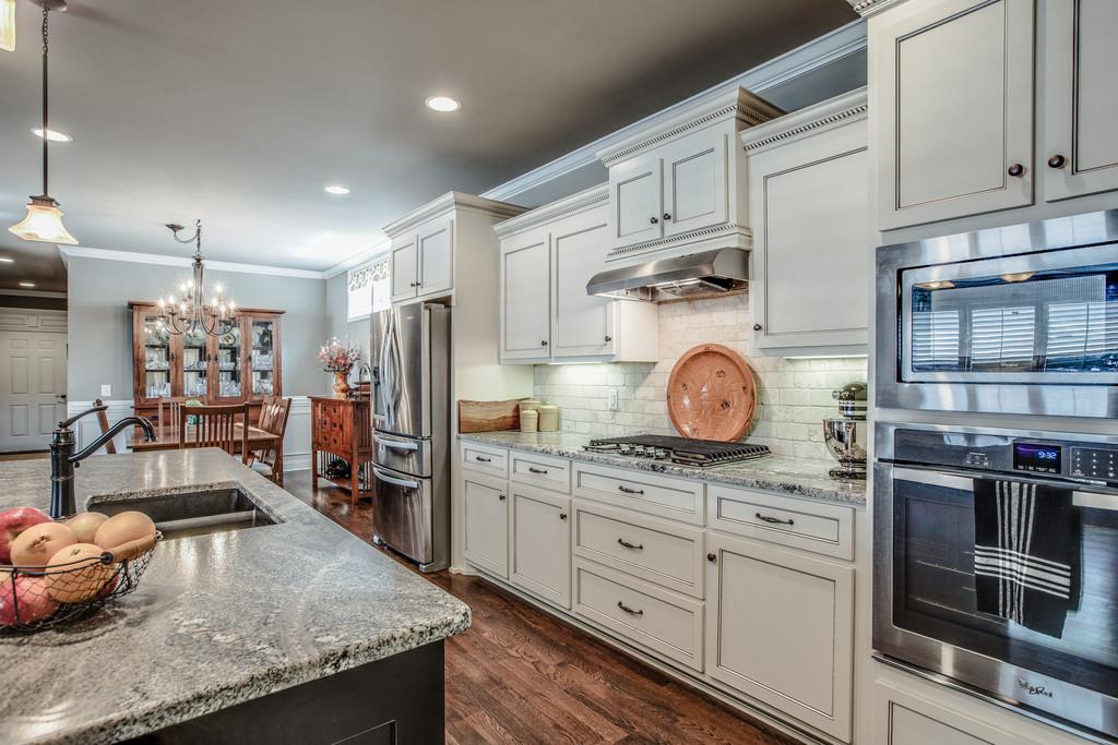 4128 Turnberry Road Spring Hill, TN 37174 - Photo 15 of 30 a kitchen with stainless steel appliances granite countertop a sink stove and refrigerator