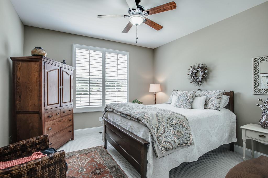 4128 Turnberry Road Spring Hill, TN 37174 - Photo 22 of 30 a bedroom with a bed and a chandelier
