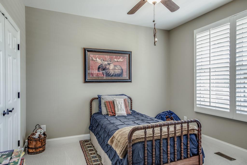 4128 Turnberry Road Spring Hill, TN 37174 - Photo 23 of 30 a bedroom with a bed and a chandelier