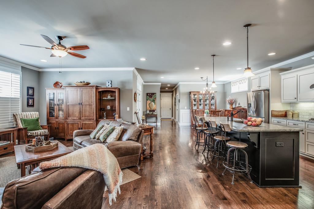 4128 Turnberry Road Spring Hill, TN 37174 - Photo 4 of 30 a view of a dining room and livingroom with furniture wooden floor a chandelier
