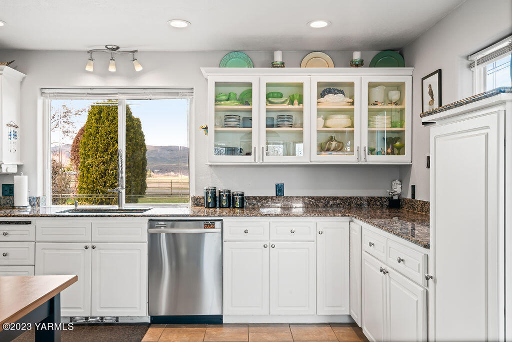 15010 Fisk Road Yakima, WA 98908 - Photo 13 of 45 a kitchen with granite countertop a stove a sink and cabinetry