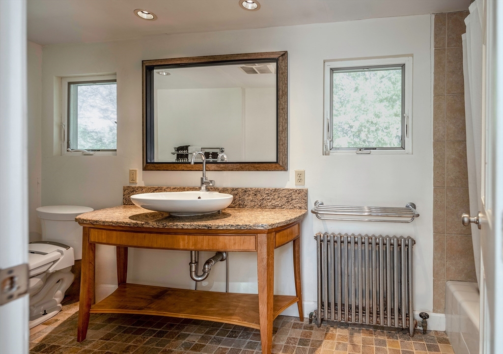 8 Old Essex Road Ipswich, MA 01938 - Photo 11 of 42 a bathroom with a sink a mirror and a window