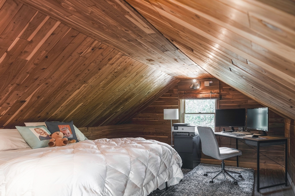 8 Old Essex Road Ipswich, MA 01938 - Photo 17 of 42 a bedroom with a bed a chair and a chandelier
