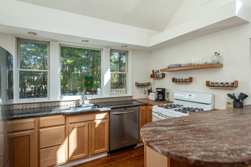 8 Old Essex Road Ipswich, MA 01938 - Photo 26 of 42 a kitchen with stainless steel appliances granite countertop a sink and a stove