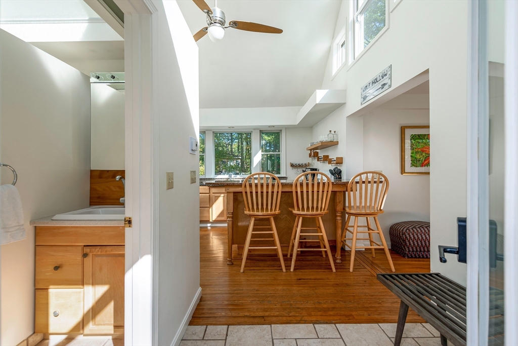 8 Old Essex Road Ipswich, MA 01938 - Photo 27 of 42 a dining room with furniture a rug and a floor to ceiling window