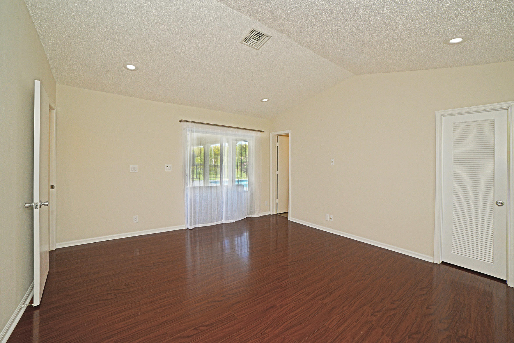 9053 Old Pine Road Boca Raton, FL 33428 - Photo 32 of 42 a view of an empty room with wooden floor and a window