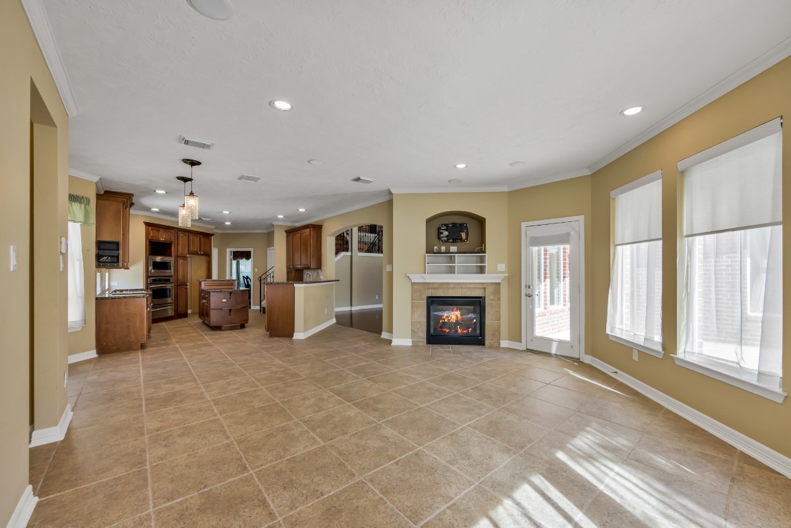 10410 Kilbride Way Court Spring, TX 77379 - Photo 14 of 49 The den is such a great space for enjoying cozy conversation or curling up with your favorite book. A great view of the backyard, plus another gas fireplace. (There are THREE fireplaces in this home!)
