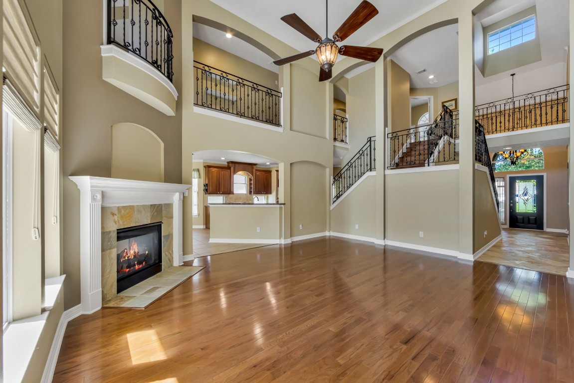 10410 Kilbride Way Court Spring, TX 77379 - Photo 16 of 49 The formal living area has so many gorgeous features! From the soaring ceilings to the views of the beautiful balconies from the 2nd floor and the gorgeous stair railings.