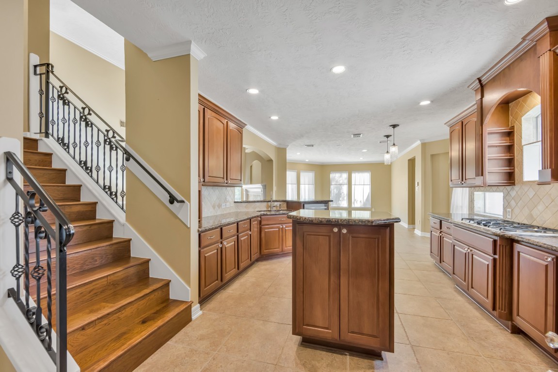 10410 Kilbride Way Court Spring, TX 77379 - Photo 9 of 49 Second staircase leads directly into the kitchen, making morning coffee easily accessible to those who are staying on the 2nd floor.
