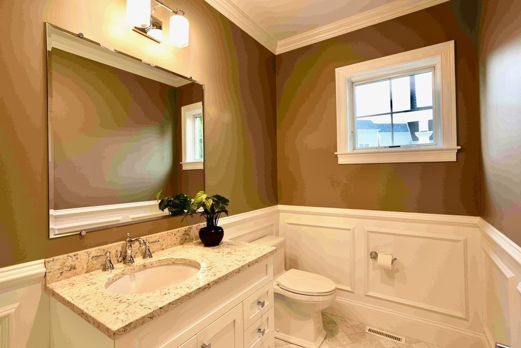 185 Hillside Avenue, Unit 185 Needham, MA 02494 - Photo 11 of 32 a bathroom with a granite countertop sink mirror vanity and toilet