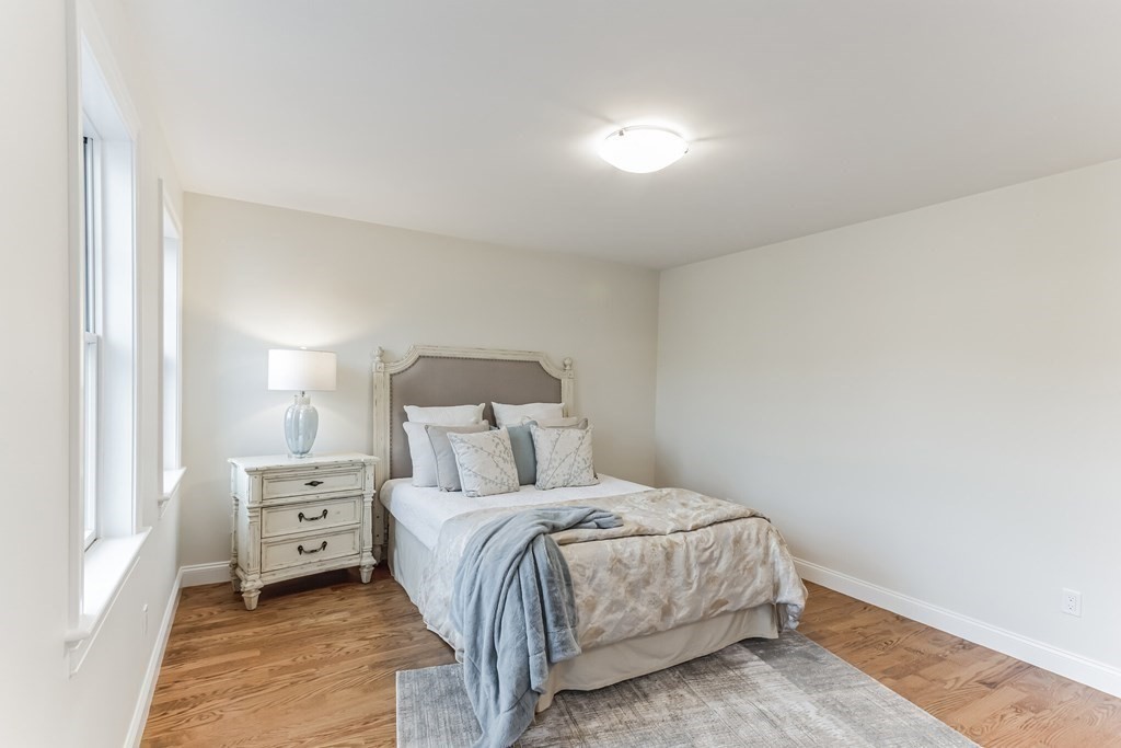185 Hillside Avenue, Unit 185 Needham, MA 02494 - Photo 20 of 32 a bedroom with a bed and a night stand