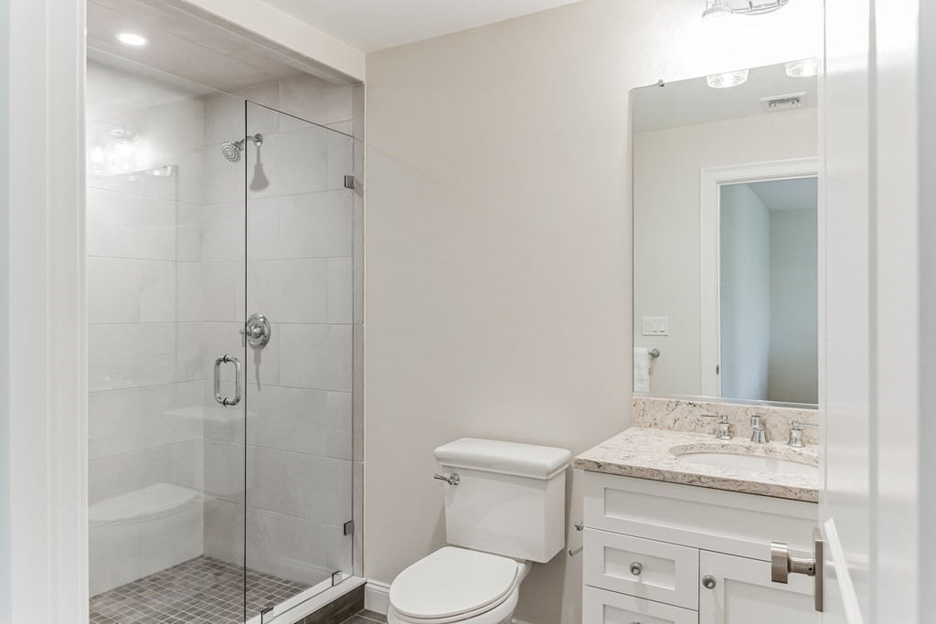 185 Hillside Avenue, Unit 185 Needham, MA 02494 - Photo 22 of 32 a bathroom with a granite countertop sink toilet and shower