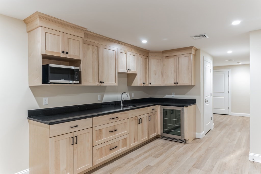 185 Hillside Avenue, Unit 185 Needham, MA 02494 - Photo 23 of 32 a kitchen with granite countertop a sink a stove and cabinets
