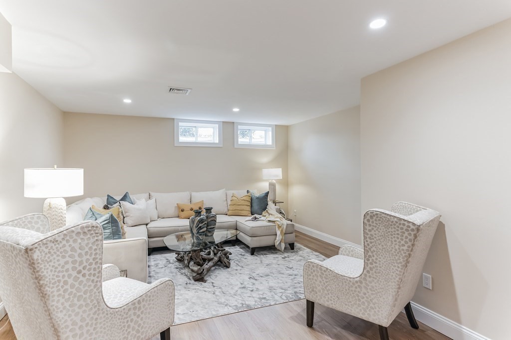 185 Hillside Avenue, Unit 185 Needham, MA 02494 - Photo 24 of 32 a living room with furniture and a lamp