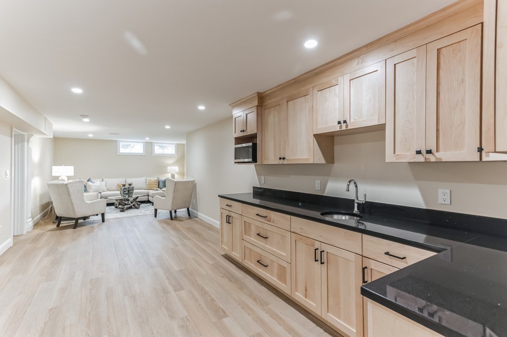 185 Hillside Avenue, Unit 185 Needham, MA 02494 - Photo 25 of 32 a open kitchen with granite countertop white cabinets and sink