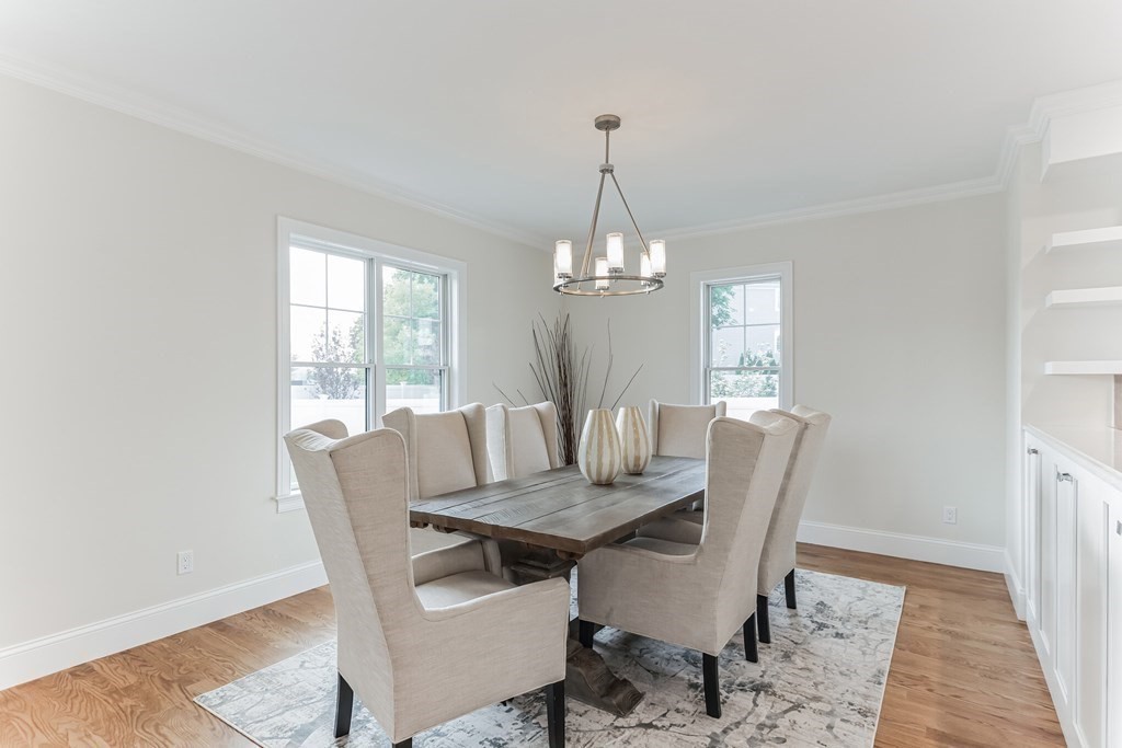 185 Hillside Avenue, Unit 185 Needham, MA 02494 - Photo 6 of 32 a view of a dining room with furniture a chandelier and wooden floor